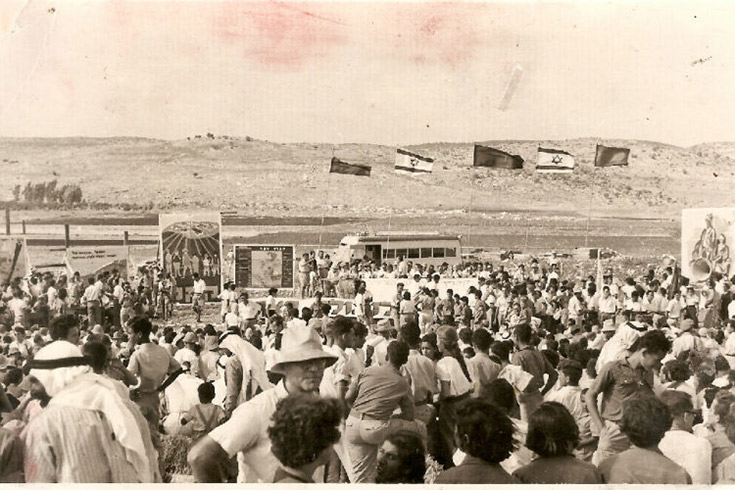 Large crowd of people outdoors in the desert