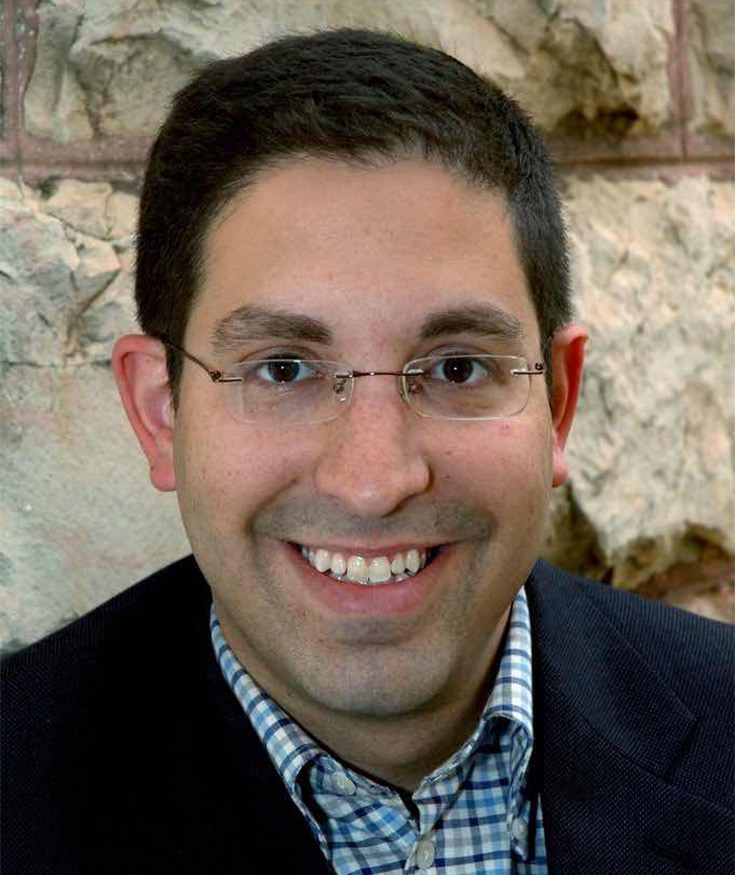 Headshot of a smiling man