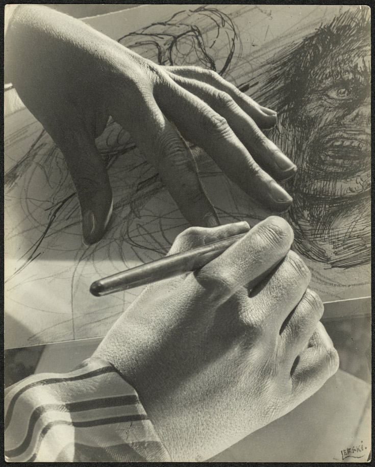 Image of two hands, drawing on paper