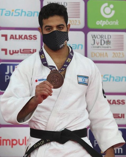 Man in a judo uniform and a mask