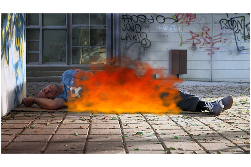 Man on fire sleeping peacefully on the ground
