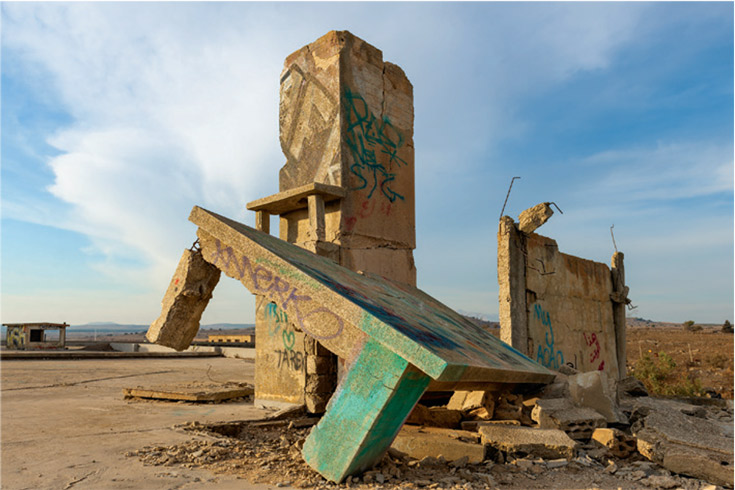 Ruins of a concrete building in a desolate-looking landscape