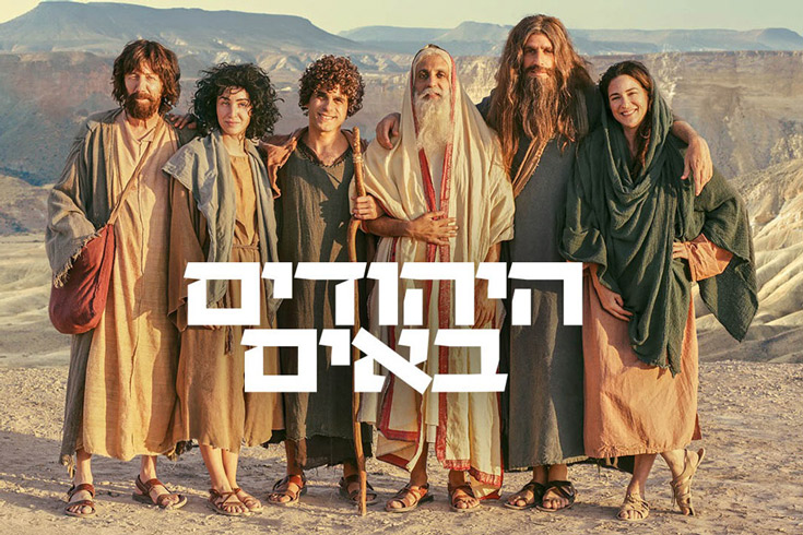 Cast photo - smiling group of people posed in Biblical-era clothes standing in the desert
