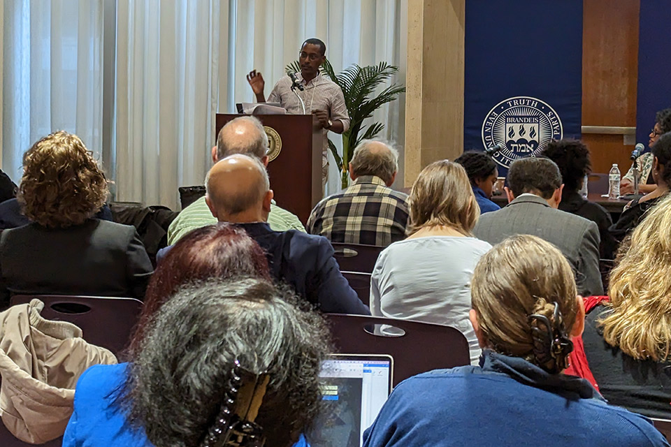 A man at a podium speaks to an audience