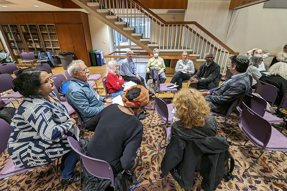 A group of people seated in a circle.