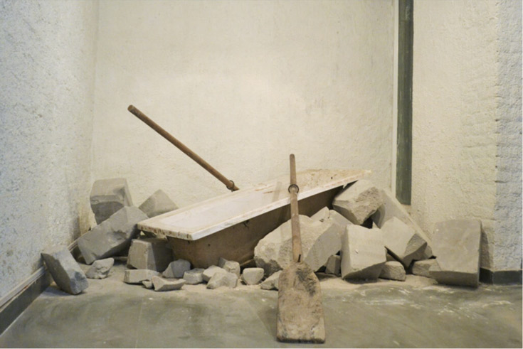 White or beige room with rubble and a paddle on the floor.