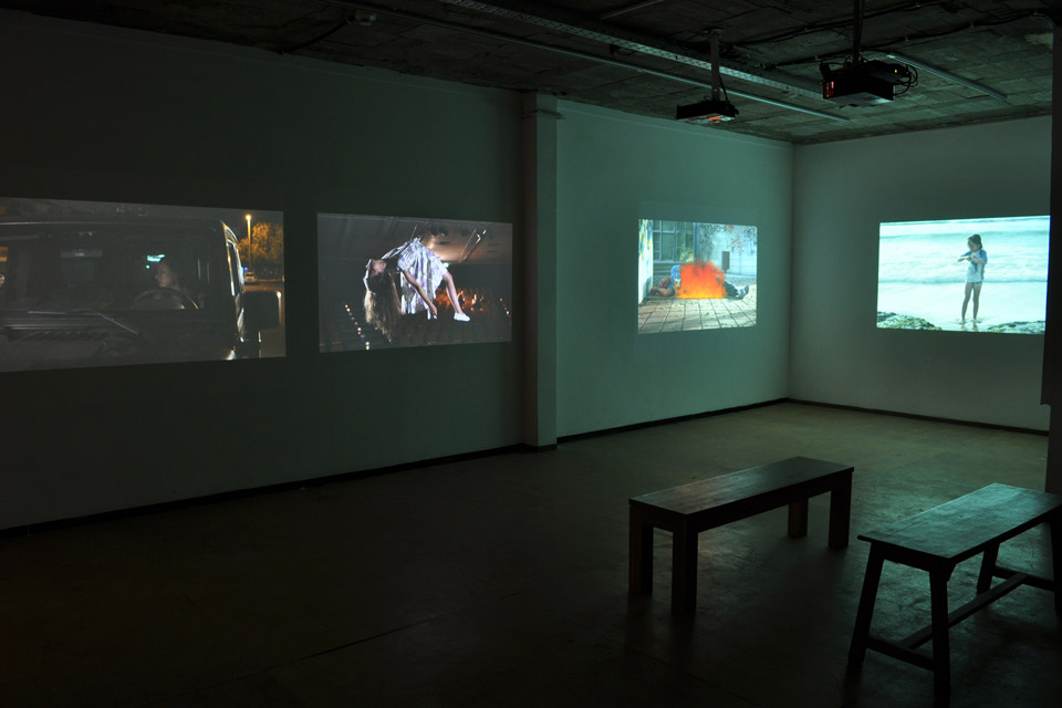 Film screens in a darkened exhibition space