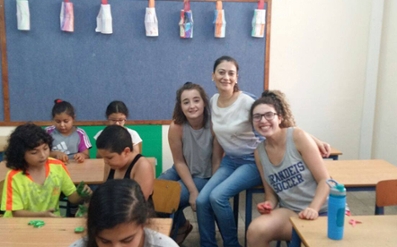 Mya with students at Achva School