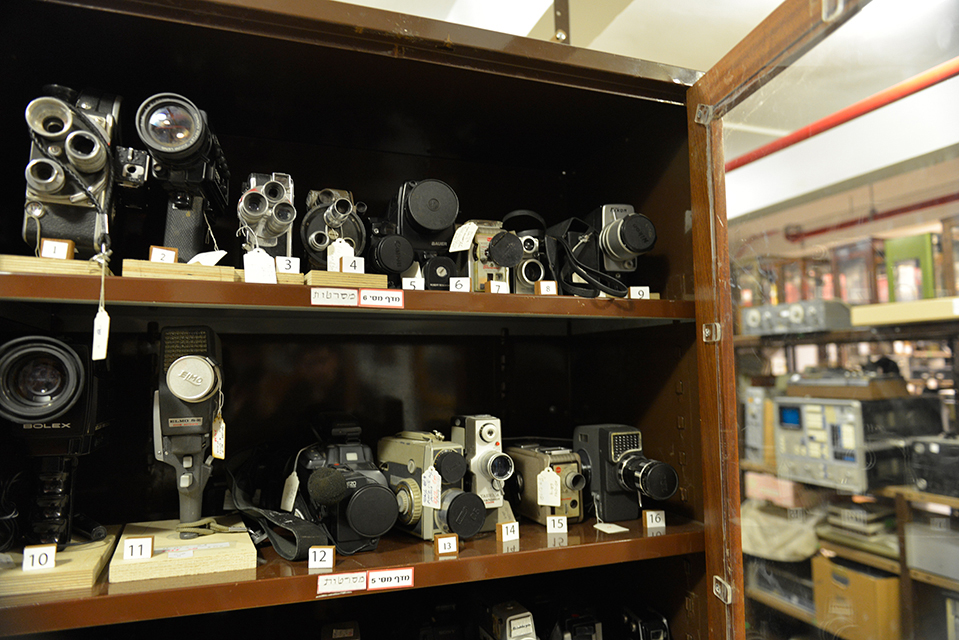 Old movie cameras on display case shelves