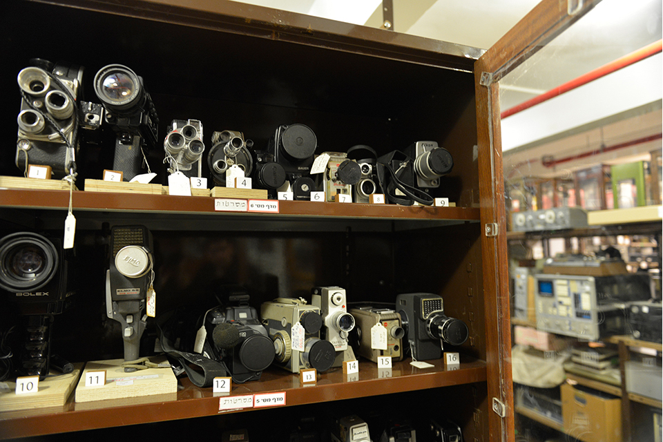 Old movie cameras on display case shelves
