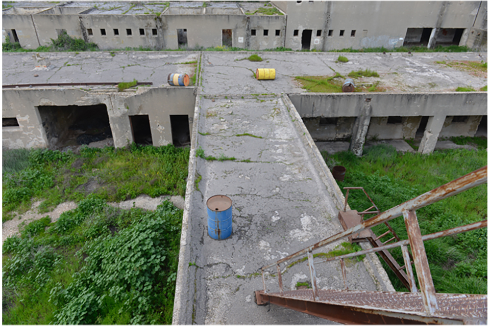 Industrial ruins - concrete walkways, a rusted ladder