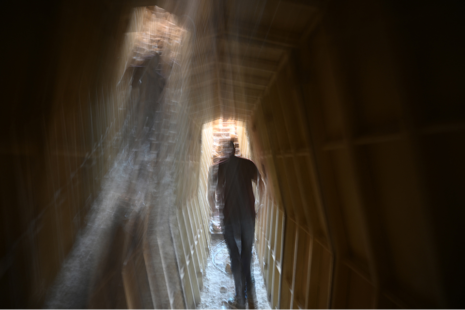 Distorted image of a person walking through a tunnel