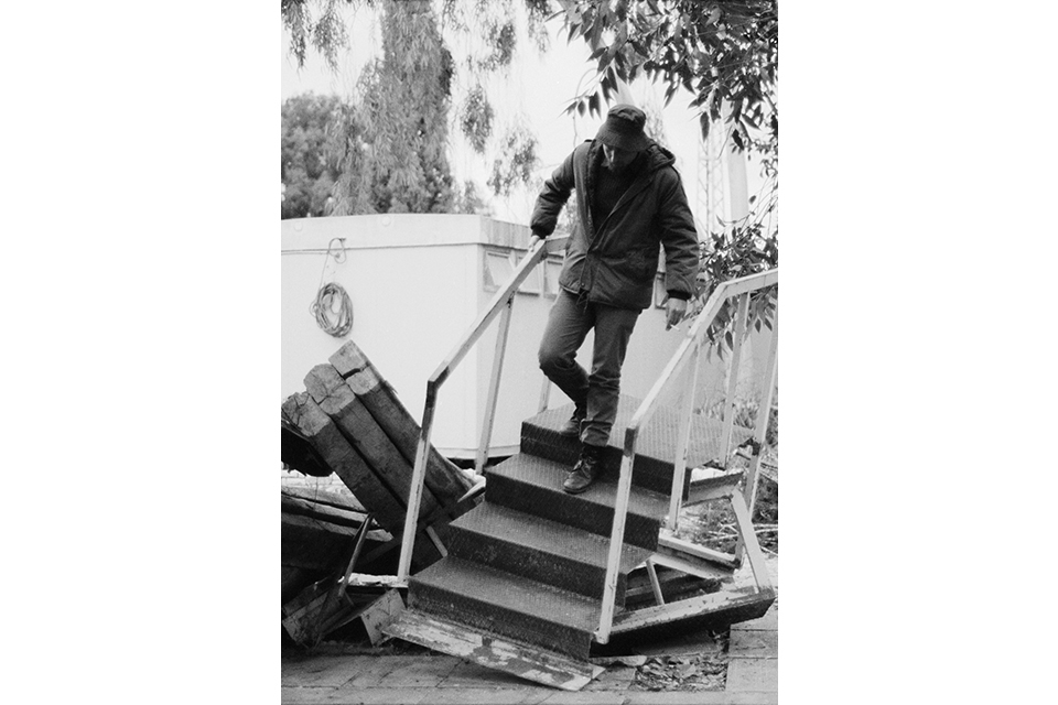 Man walking down broken stairs