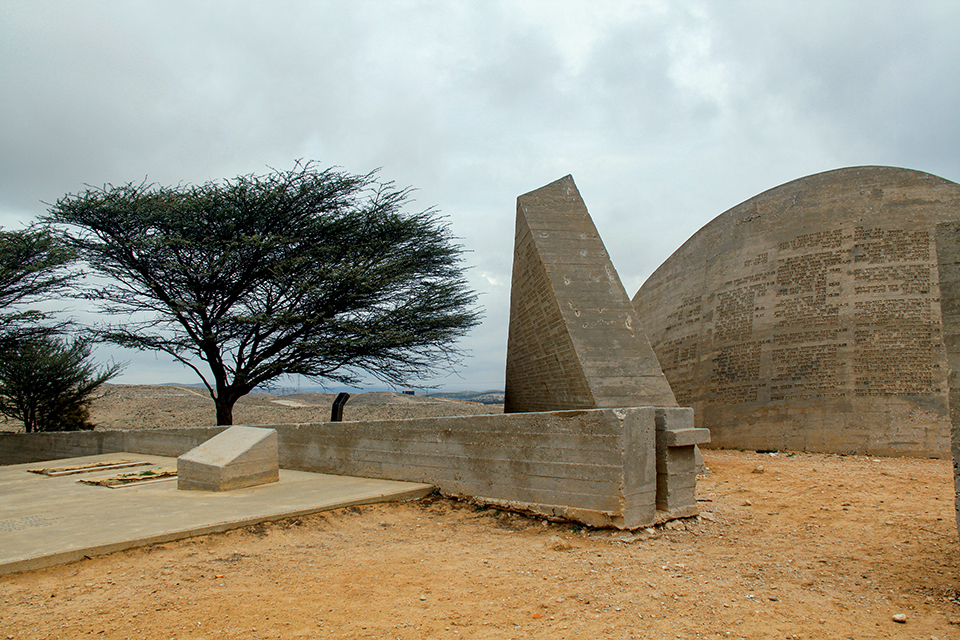 Large concrete shapes with what appears to be columns of words printed on them 