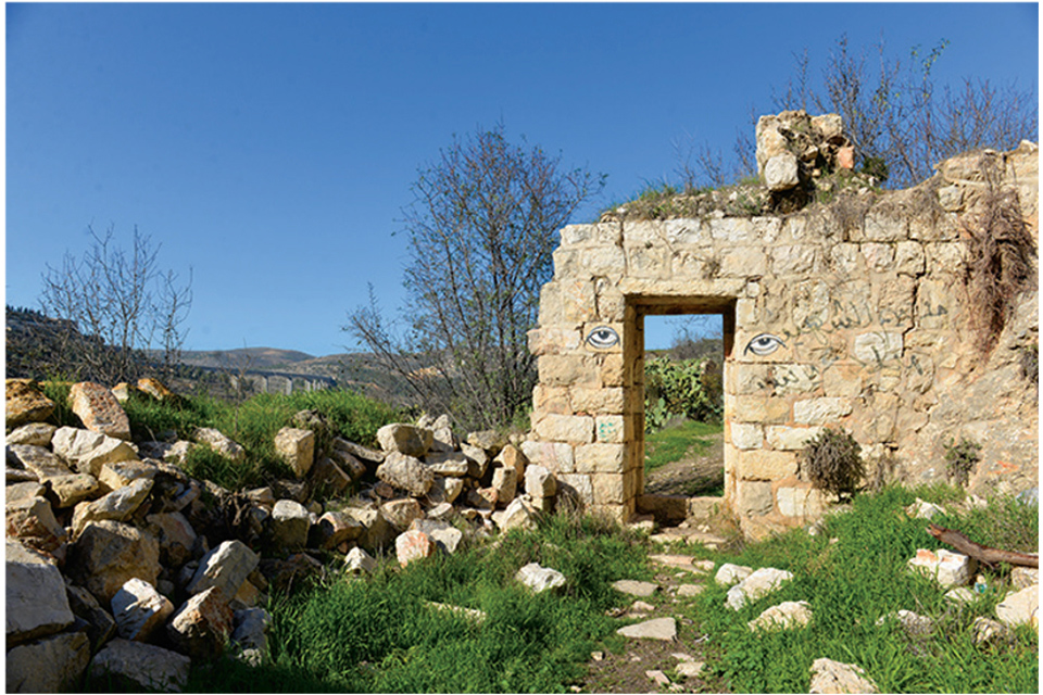 Eyes painted on either side of a doorway in building ruins