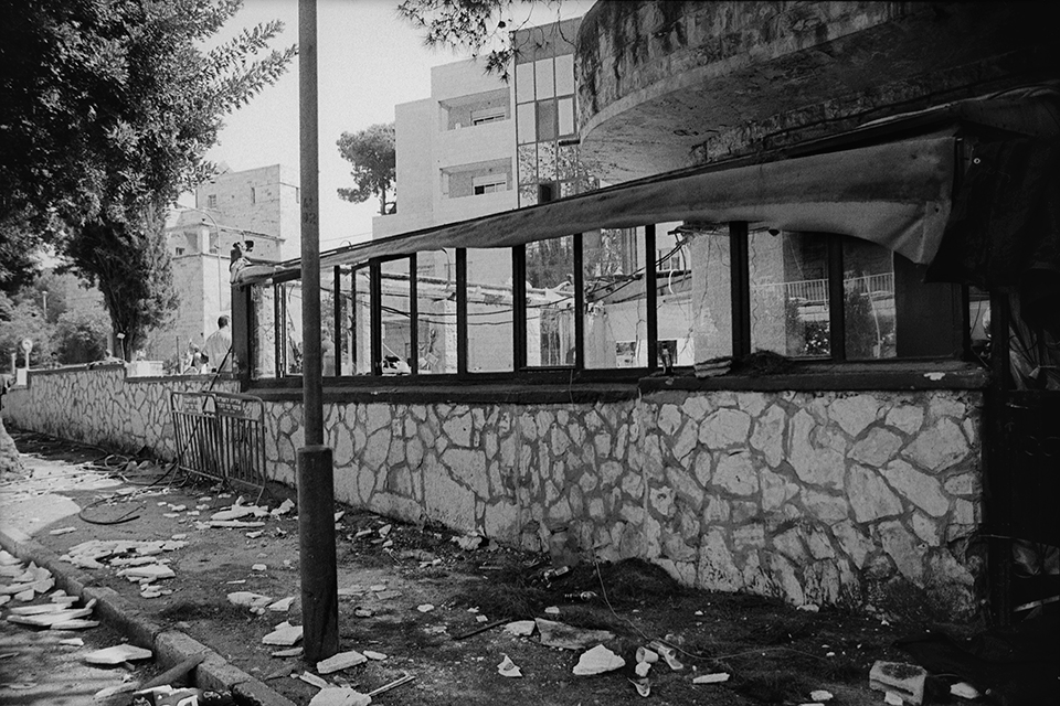Remnants of a bombed cafe, in black and white