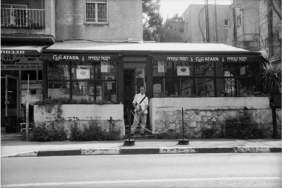 A street-side cafe, in black and white