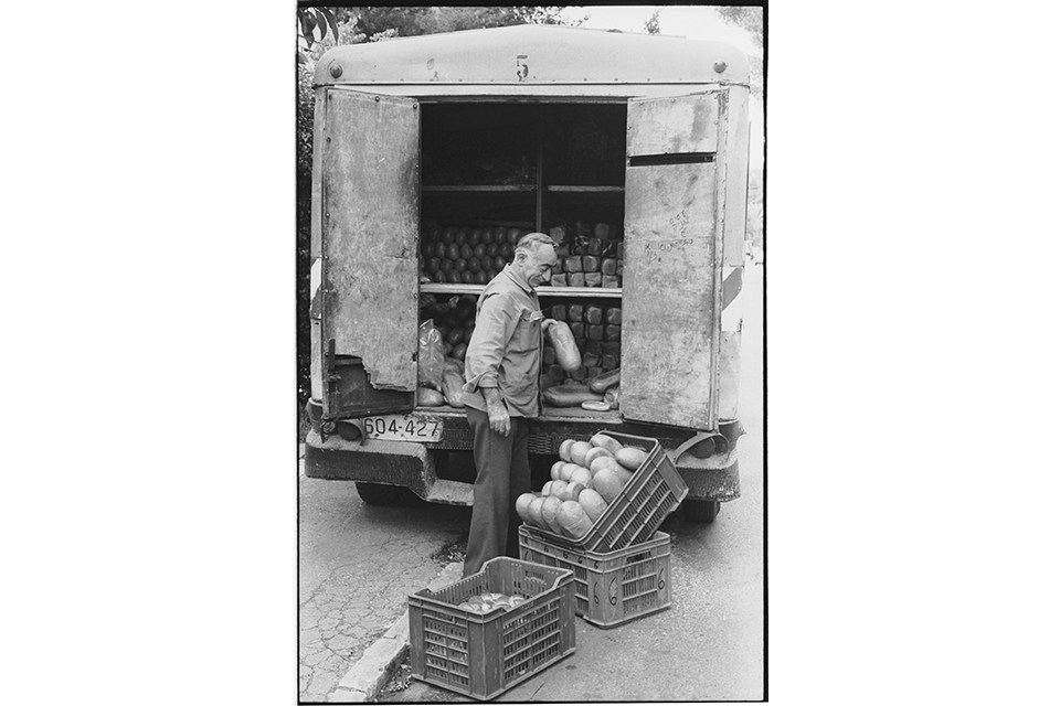 A man packing loaves of bread into a truck