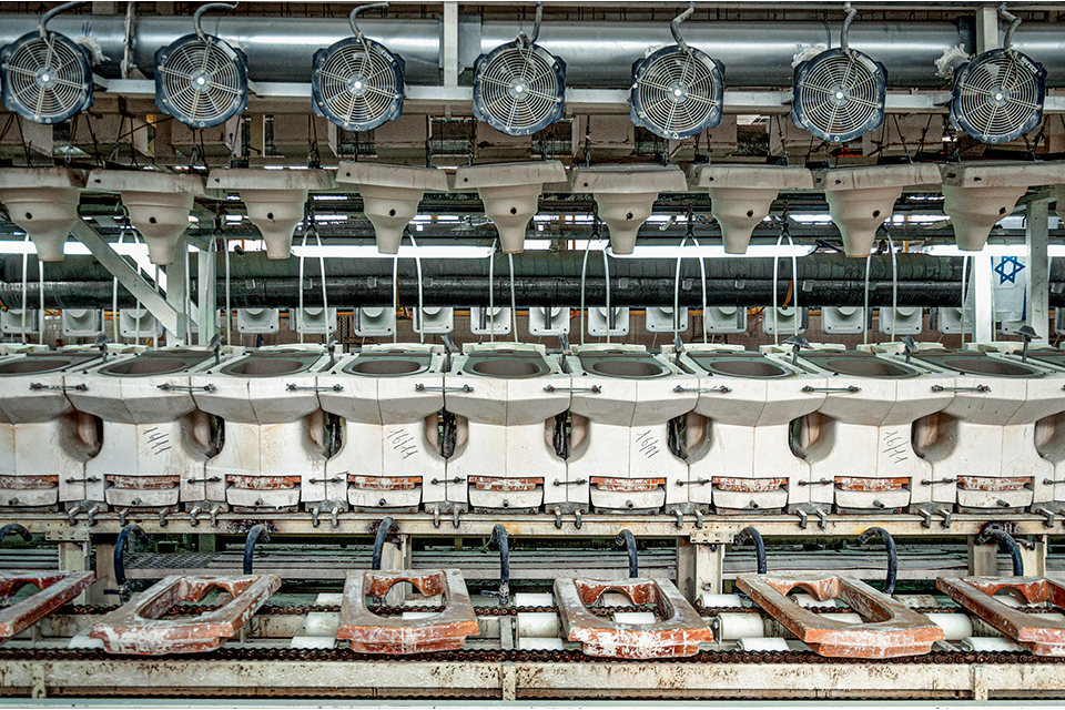 Rows of mechanical-looking objects laid out in the style of a production line