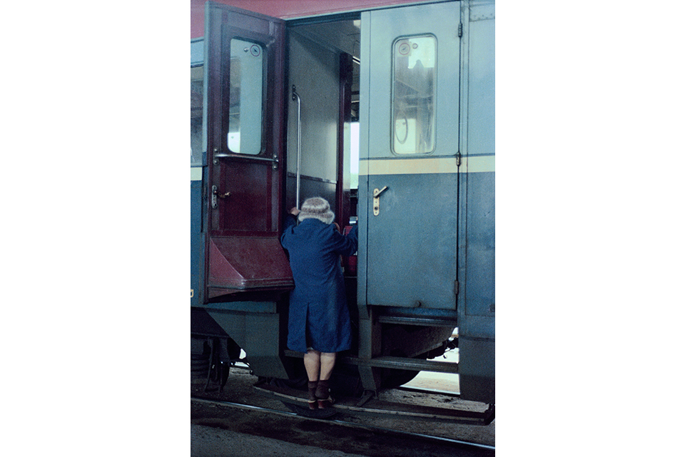 Woman climbing onto a train