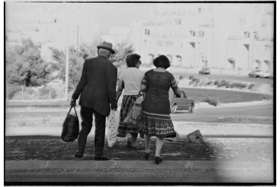 Three people crossing a street