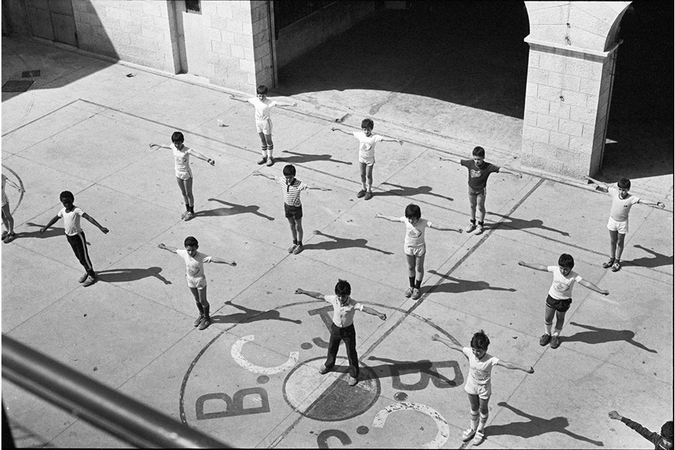 Arial shot of children with their arms spread wide