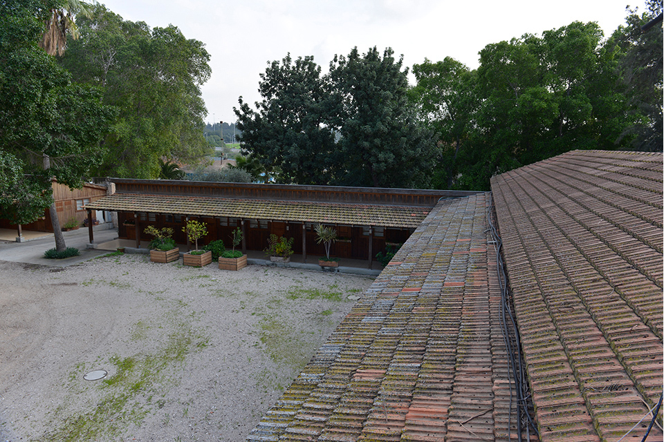 A yard bordered on two sides by an open structure