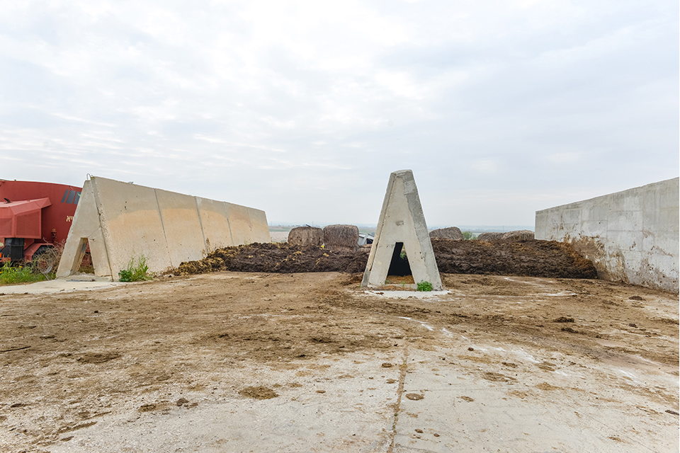 Triangular concrete structures amid dirt