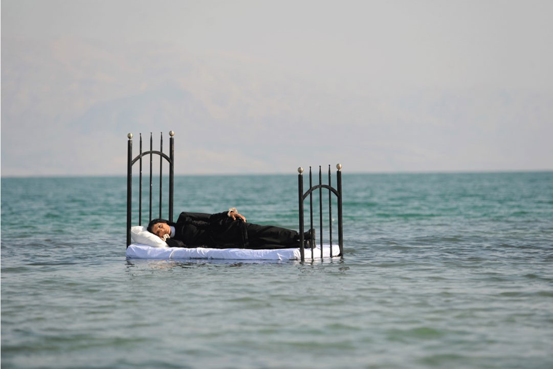 Woman on a bed in the sea