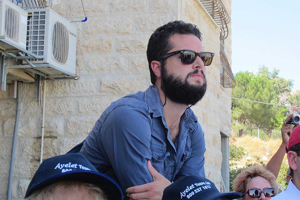 Walker Robins looking thoughtful, outdoors in Israel