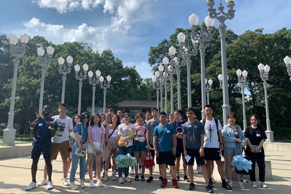 Students posing in front of street lights