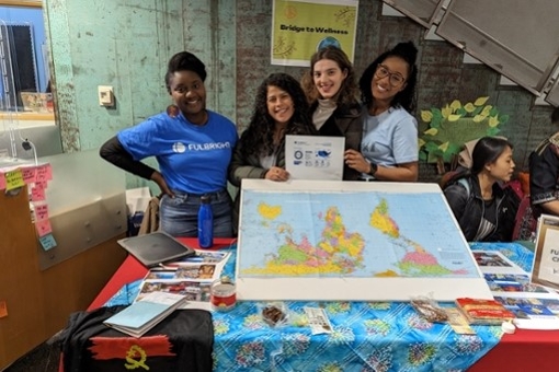 Fulbright scholars at a table with a map.