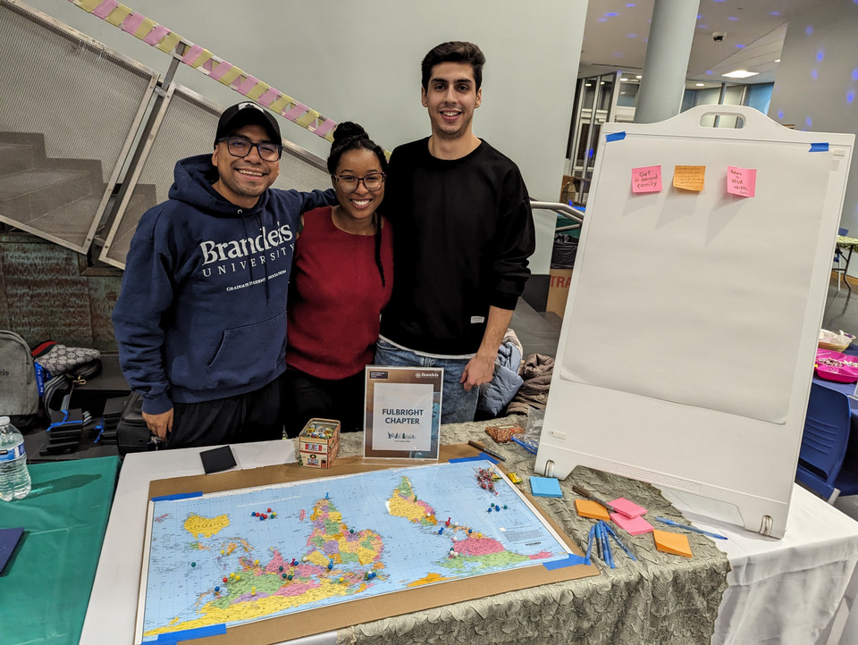 Fulbright scholars at the Global Bazaar standing behind a table