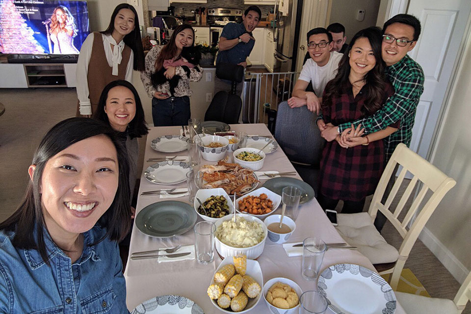 Students smiling with their Thanksgiving host