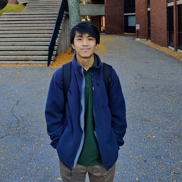 Ekin standing in front of stairs