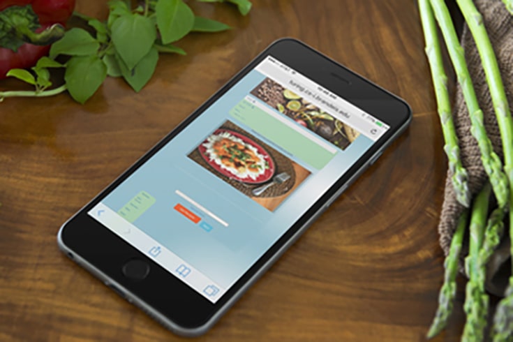 mobile phone on table displaying the chef's assistant app created by Brandeis students.