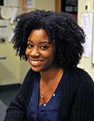 adriana gleaton smiling while seated in classroom