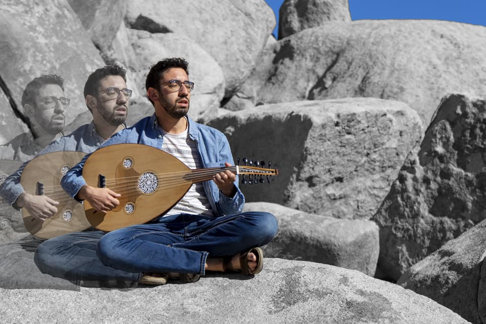 Yoni Battat plays the oud outside.
