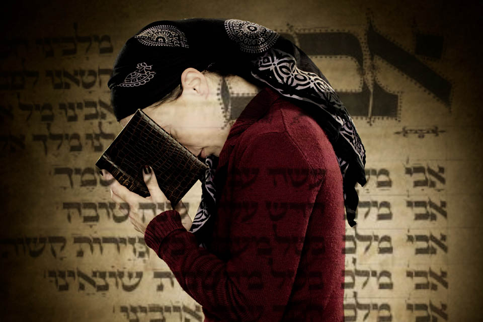 Women praying using prayer book