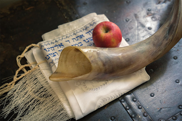 Shofar, apple, and Jewish prayer shawl
