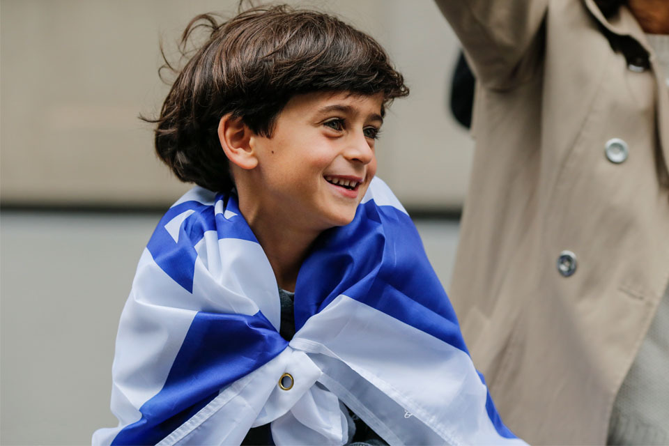 Boy wrapped in Israeli flag