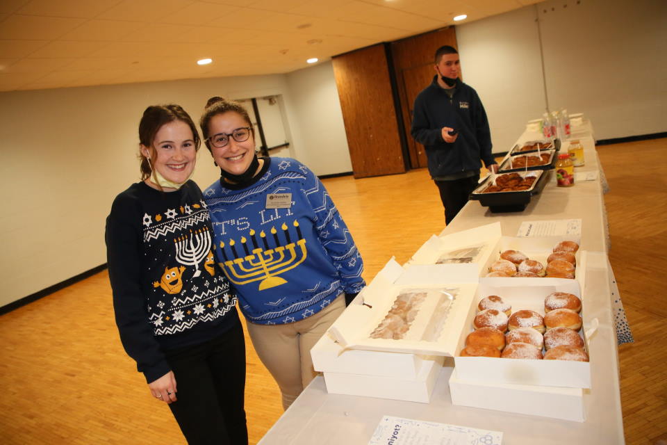 Students looking at Hanukkah donuts