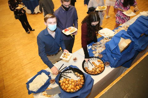 Students at a banquet table for Yom Kippur break fast 