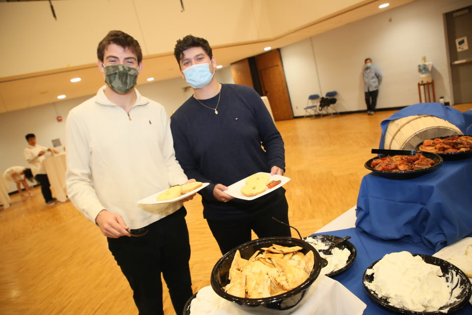 Students holding plates of food