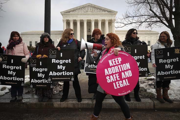 Protesters on both sides of the abortion issue gather in front of the U.S. Supreme Court.