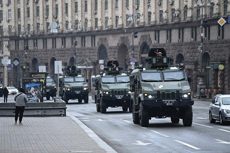 Ukrainian military vehicles move past Independence Square in central Kyiv on February 24, 2022.