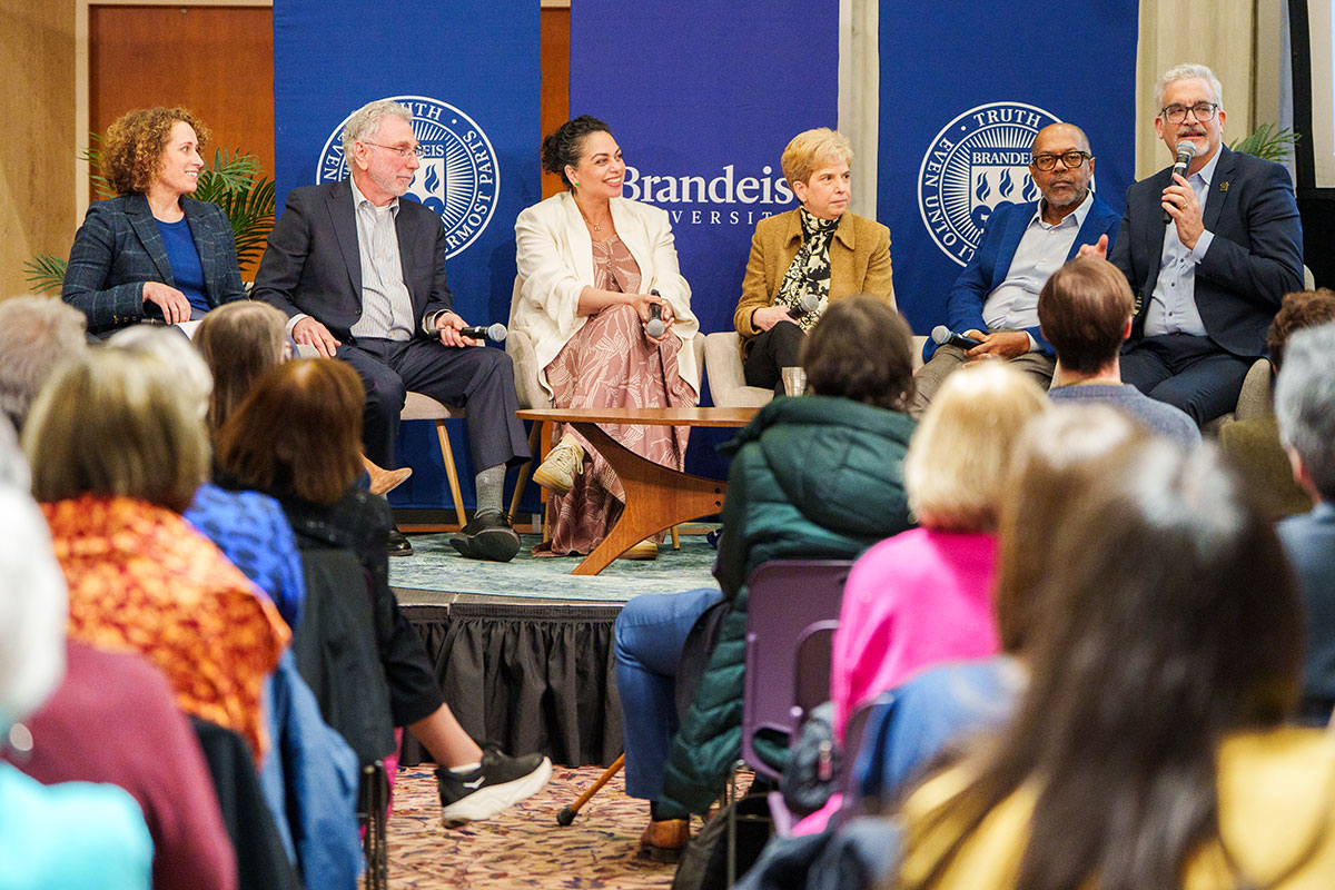Panelists speaking on stage at the Carapezza lecture series event.