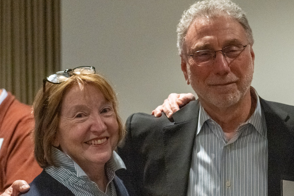 Martin Baron and Eileen McNamara smile next to each other.