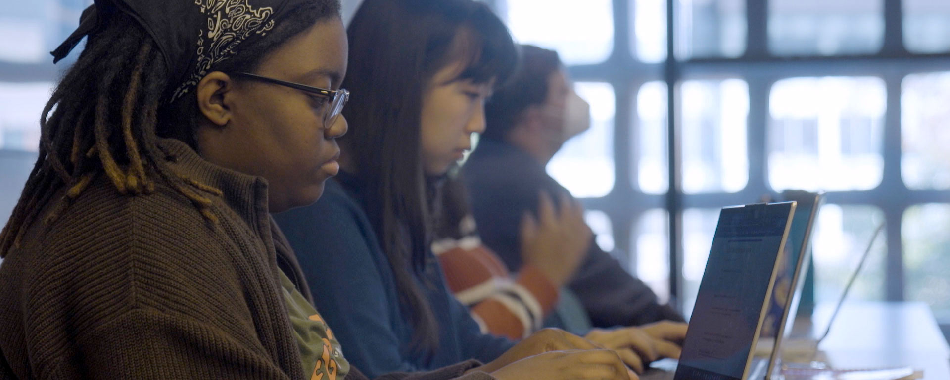 Students type on computers