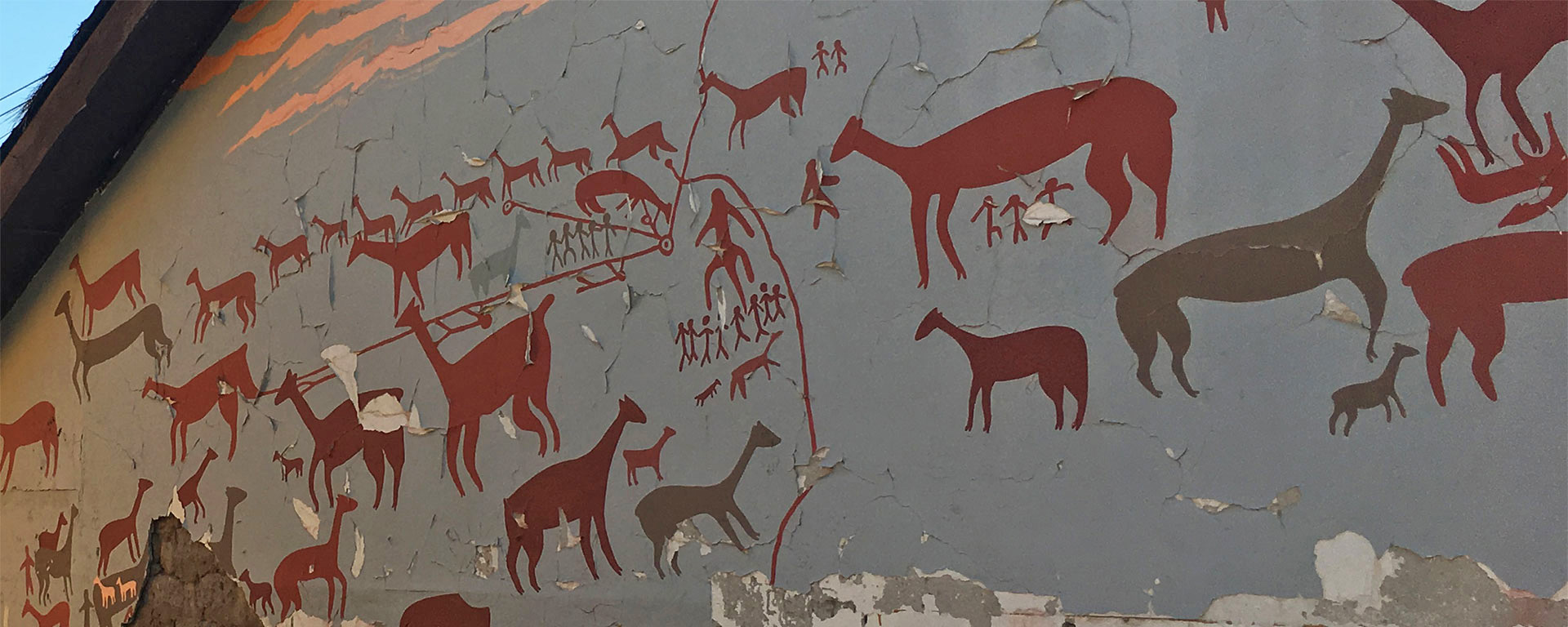 Painted animal graphics on the side of a building.